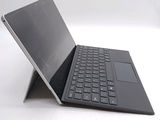 a laptop with a keyboard sitting on top of it