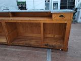 a wooden cabinet with a metal top on the floor