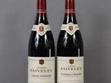 two bottles of wine sitting on top of a glass table