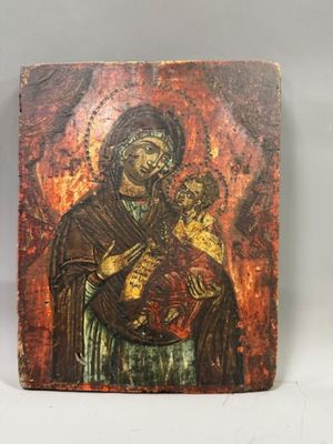 an old wooden icon of a woman holding a child