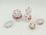 four pieces of porcelain on a white surface