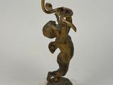 bronze figurine of a woman holding a flower on a marble base