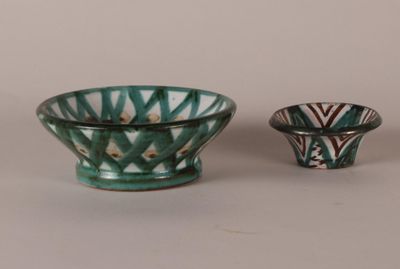 two small bowls sitting next to each other on a table