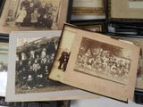 many old photos of people in a group on a table