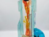 a glass sculpture of a building with a fire inside of it
