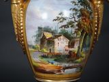 a vase with a painting of a farm on it