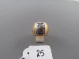 a ring that is on a table with a price tag