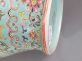 a blue vase with a floral design on it