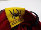 a close up of a red shoe with a spider on it