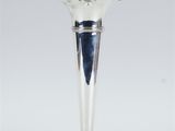 an image of a silver vase sitting on top of a table