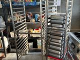 many trays of food that are on a rack in the kitchen