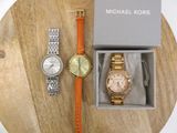 michael kors watch and bracelet set in a box on a wooden table