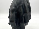 sculpture of a hand with a ring on it ' s finger