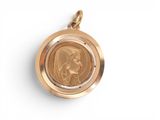 a close up of a gold locke with a picture of a woman on it