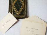 a small book and a small card on a table