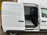 a white van with its doors open in a parking lot