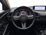 a steering wheel and dashboard of a car with a clock on it