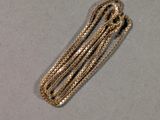 a gold necklace with a chain attached to it
