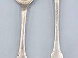 two silver spoons and a spoon with a spoon in the middle