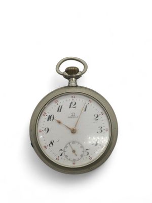 une montre de poche en argent posée sur une surface blanche, sur fond blanc
