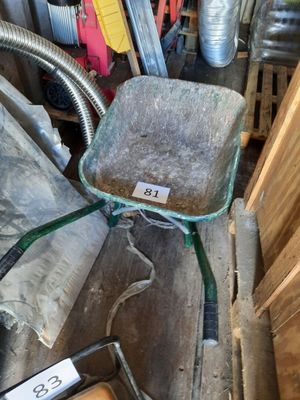a wheelbarrow with a seat on it in a pile of wood