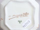 a small white vase with a label on it