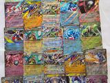 a pile of pokemon cards sitting on top of a table
