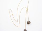 a gold necklace with two smoky quartz drops on a gold chain
