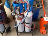 a cart with two cylinders and a hose on it