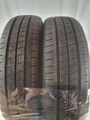 two tires are wrapped in plastic on a white surface