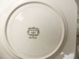 a white plate with a picture on it sitting on a table