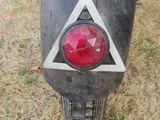 a close up of a motorcycle with a triangle on the back