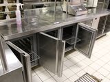 a large stainless steel counter top in a commercial kitchen