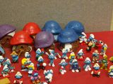 a lot of smurfs that are on a red table