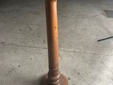 a wooden table with a wooden top in a garage