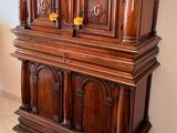 a large wooden cabinet in the middle of a room