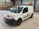 a white van parked in a warehouse with a ladder on the roof