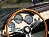 steering wheel and dashboard of a classic sports car in a parking lot