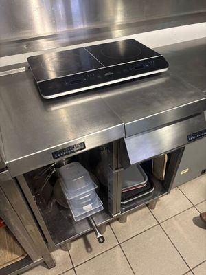 stainless steel counter top in a commercial kitchen with a laptop on it