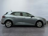 the grey car is parked on the concrete floor in the room