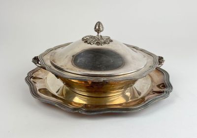 an antique silver plate with a lid and a saucer on it