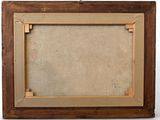 an old picture frame with a picture hanging on the wall
