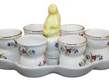 a tray with cups and a bird figurine on it