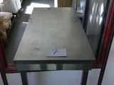 a table that has a sign on it in the middle of a room