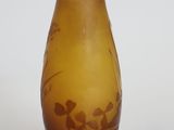 a brown glass vase with a floral design on it