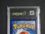 the pokemon card is in the plastic case on the table