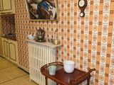 a small table in the middle of a room with a painting on the wall