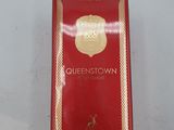 a close up of a box of perfume on a white surface