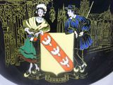 a plate with a picture of two people holding a shield