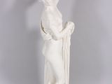 white statue of a woman holding a bird in her hand
